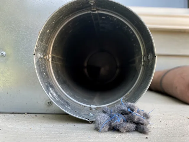 Colchester Dryer Vent Cleaning technician using specialized equipment to clear severe dryer vent blockage in Colchester
